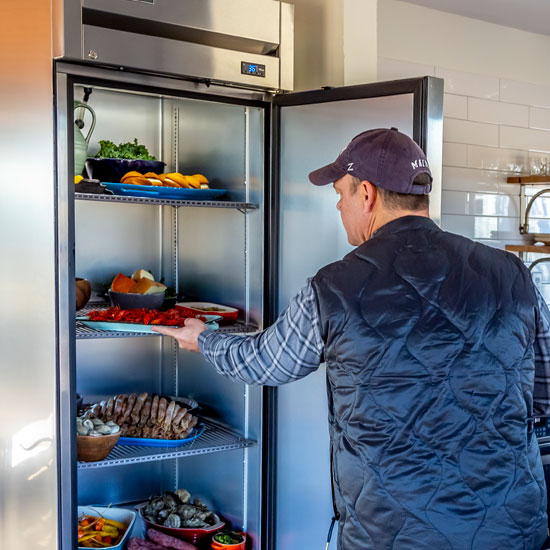 Peacemaker Lobster & Crab - Person Grabbing Food from Fridge