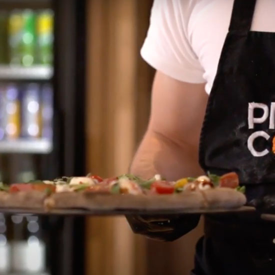 Pizza Cosy - Person Holding Pizza